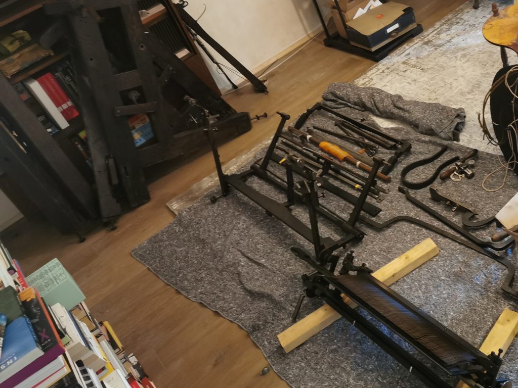 Components of a framework knitting machine laid out on the floor