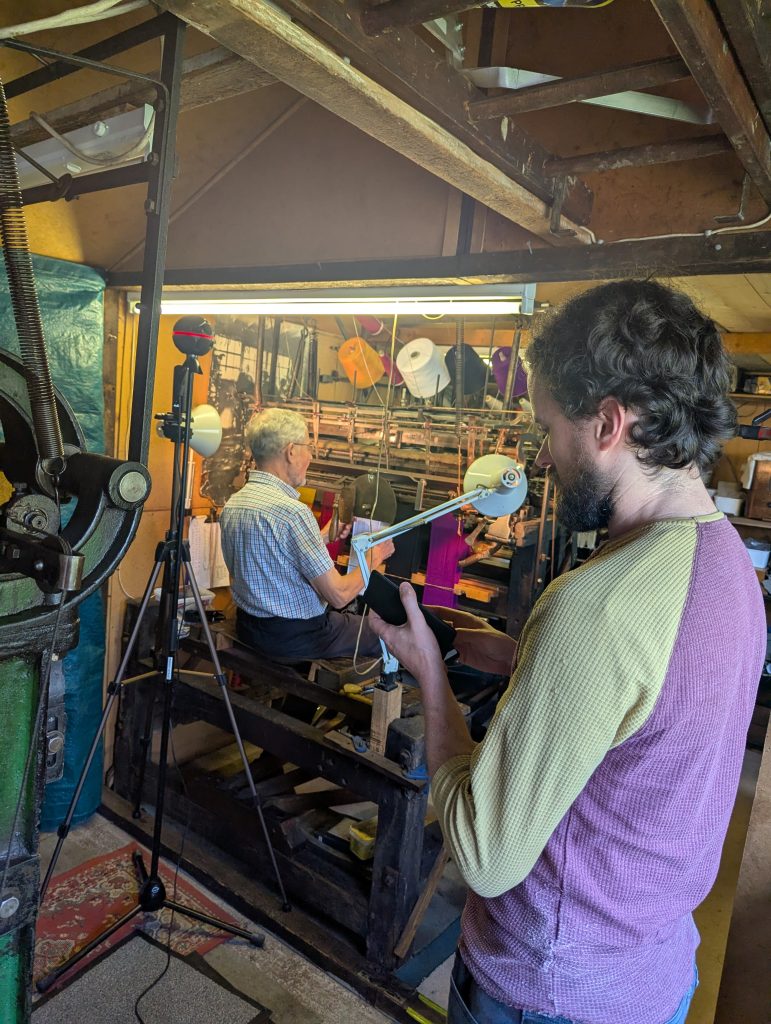 Adam Hill checking the 3D audio microphone configuration while Martin Green operates a hand frame.