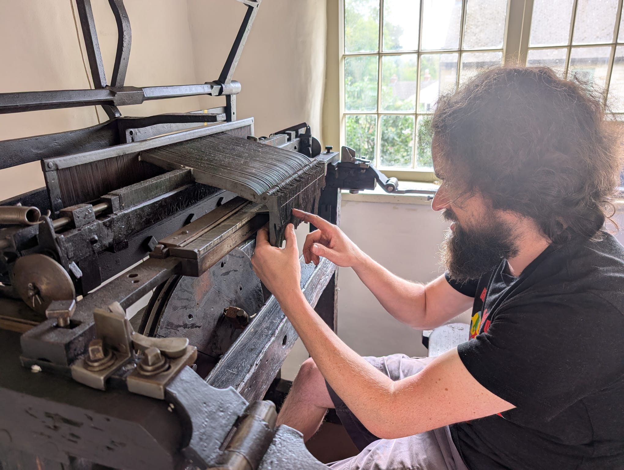 An 18th century framework knitting maching being reassembled.